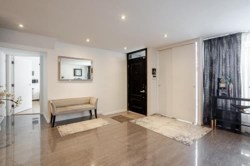 a living room with a chair and a mirror at Majestic Villa in Downtown Griffintown in Montréal