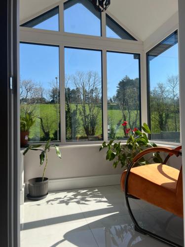 a porch with windows and a bench and plants at Holiday Home in Leap in Leap