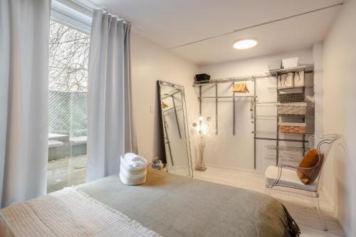 a bedroom with a bed and a mirror and a window at Majestic Villa in Downtown Griffintown in Montréal