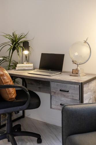 an office with a desk with a laptop on it at Majestic Villa in Downtown Griffintown in Montréal