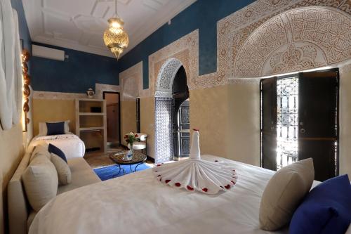 a bedroom with a large white bed in a room at Riad Atlas Dama in Marrakech