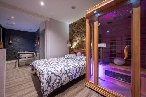 a bedroom with a bed with a large glass window at Suite pour les Amoureux_Val d'Europe Disney in Coupvray