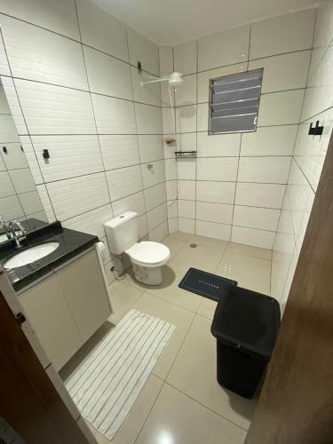 a bathroom with a toilet and a sink at Apto Novo Jardim Rosinha 04 in Sao Paulo