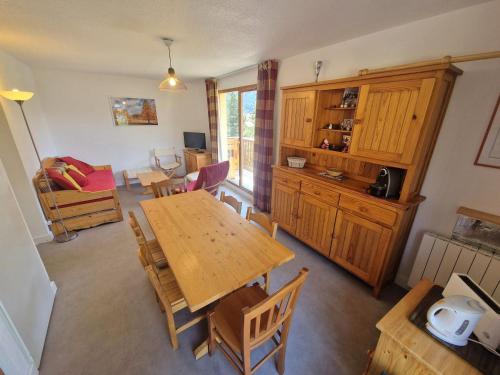 une cuisine et une salle à manger avec une table et des chaises dans l'établissement Appartement chalet 3 pièces, 4-6 pers, à Valfréjus, près des remontées mécaniques - FR-1-265-182, à Valfréjus