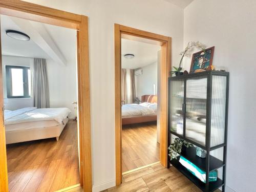 a mirror in a room with a bedroom at Apartments Azimut Rezevici in Budva
