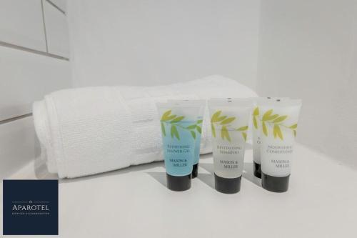 a group of four products sitting next to a roll of toilet paper at Aparotel Serviced Apartments - Stonehenge, Amesbury Town Centre in Amesbury