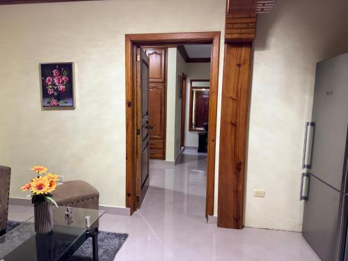 a hallway of a house with a door and a table at Hotel El Bonao in Higuey
