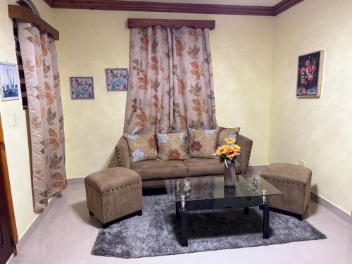 a living room with a couch and a coffee table at Hotel El Bonao in Higuey