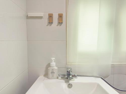 a white bathroom with a sink and a mirror at STAY ONDAM #3room #10guests in Seoul