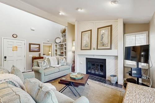 a living room with a couch and a fireplace at Surfscoter 94 in Kiawah Island
