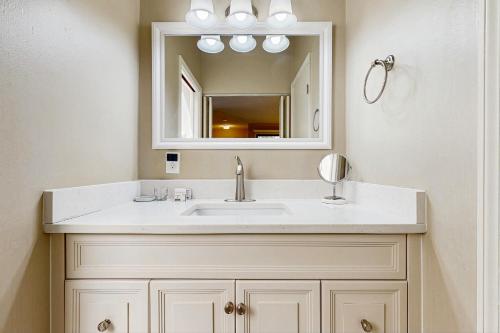 a bathroom with a sink and a mirror at Surfscoter Home in Kiawah Island