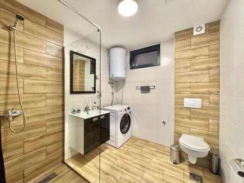 a bathroom with a toilet and a sink and a shower at Apartments Azimut Rezevici in Budva
