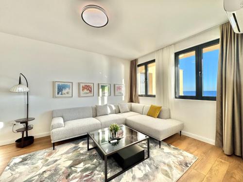 a living room with a couch and a table at Apartments Azimut Rezevici in Budva