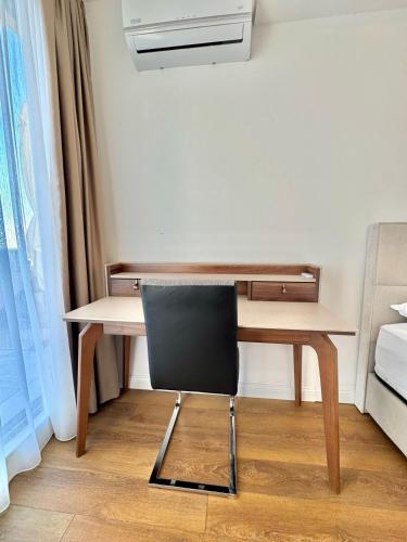 a desk and a chair in a room at Apartments Azimut Rezevici in Budva