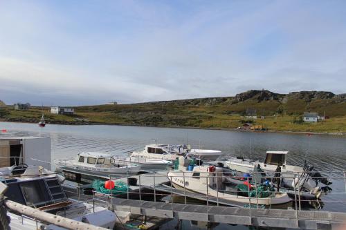 a group of boats docked at a dock in the water at Hotel Repvåg in Repvåg