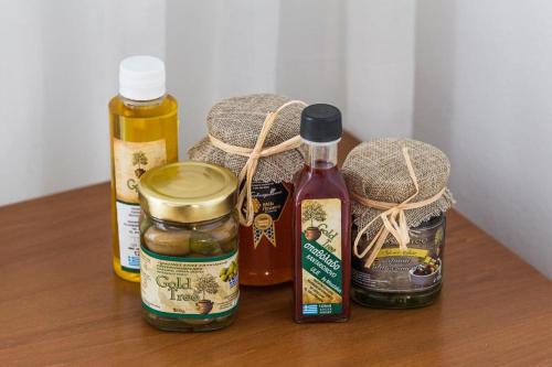 a wooden table with jars of food on it at Galini apartments Polyhrono in Kassandria