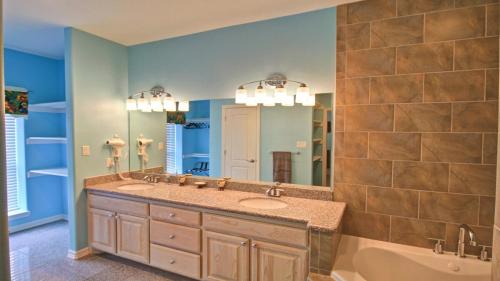 a bathroom with two sinks and a tub and a mirror at FamReunion,EVcharger,3LotsToBeach,HeatedPool,Jacuzzi in South Padre Island
