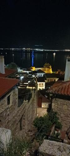 a view of a harbor at night with a ship at Stone Clock's House in Nafpaktos