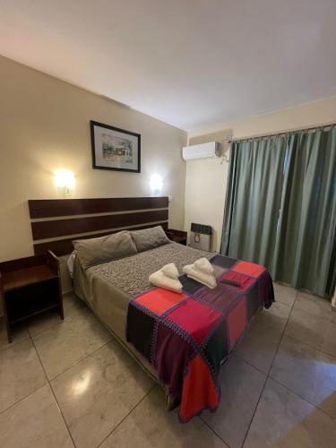 a bedroom with a bed with two towels on it at Hotel Francia in San Rafael