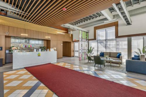 eine Bürolobby mit einer Rezeption und einem roten Teppich in der Unterkunft KC Inn Hotel Kansas City in Kansas City