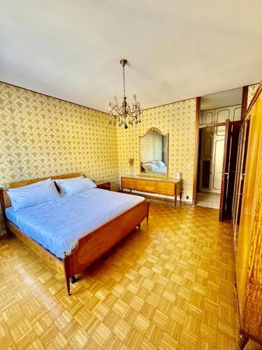 a bedroom with a bed and a chandelier at Nido tra monti in Sondrio