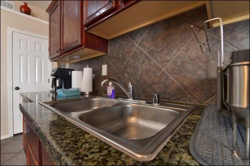 a kitchen counter with a stainless steel sink at El Paso Comfy Home in El Paso