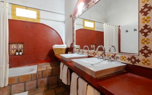 a bathroom with two sinks and a large mirror at La Vaca Tranquila in San Carlos