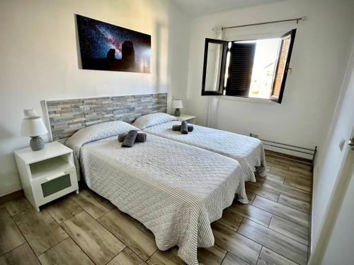 a bedroom with two beds and a window at Colorado Golf by Infinity Summer in Maspalomas