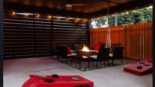 a patio with a table and chairs and a fire pit at Stylish 3BR East Side Retreat w Patio & BBQ in Austin