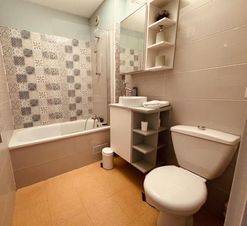 une salle de bain avec toilettes, baignoire et lavabo dans l'établissement Sete T2 avec piscine, parking, proche des plages, à Sète
