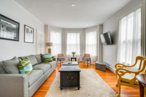 a living room with a couch and a table at Walk to Harvard Square Apartment in Cambridge in Cambridge