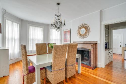 a dining room with a table and chairs and a fireplace at Walk to Harvard Square Apartment in Cambridge in Cambridge