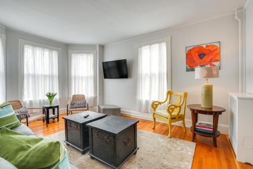 a living room with a couch and a table at Walk to Harvard Square Apartment in Cambridge in Cambridge