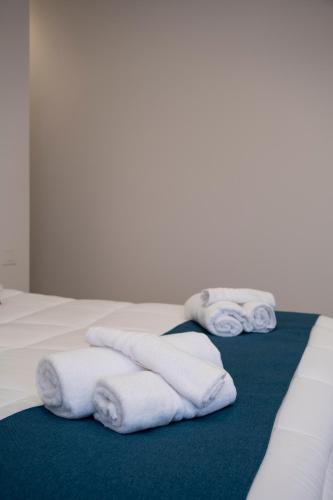 a pile of towels sitting on top of a bed at Villa Kora Suites&Pool in San Leone