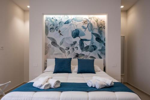 a bedroom with a large bed with towels on it at Villa Kora Suites&Pool in San Leone
