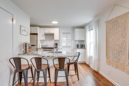a kitchen with a island with four chairs around it at Walkable Dtwn Townhome Near Campus and Palmer Square in Princeton