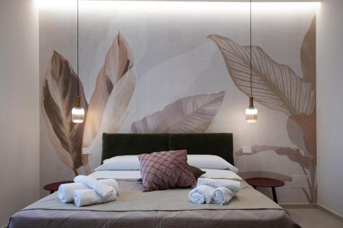 a bedroom with a bed with towels on it at Villa Kora Suites&Pool in San Leone