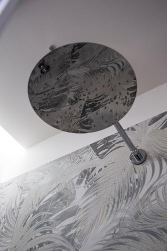 a silver lamp sitting on top of a ceiling at Villa Kora Suites&Pool in San Leone