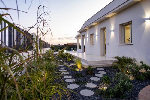 a house with a pathway in front of it at Villa Kora Suites&Pool in San Leone