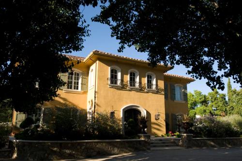 a yellow house with windows and a tree at Villa Arden Hills in Sacramento