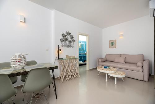 a living room with a couch and a table at Aerenia Luxury Suites in Karterados