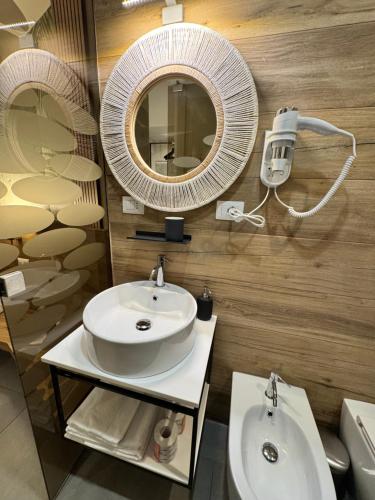 a bathroom with a sink and a mirror at Namuri Rooms in Giardini Naxos