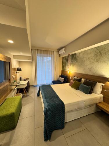 a hotel room with a large bed and a living room at Namuri Rooms in Giardini Naxos
