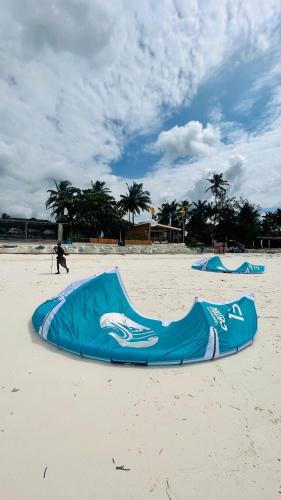 a blue kite laying on the beach on a beach at B4 BOUTIQUE in Paje
