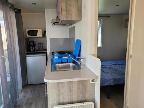 a small kitchen with a sink in a tiny house at L'hippo 51 in Saint-Martin-Plage