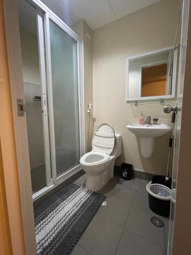 a bathroom with a shower and a toilet and a sink at Cozy City Escape - Avida Aspira Tower 1, CDO in Cagayan de Oro