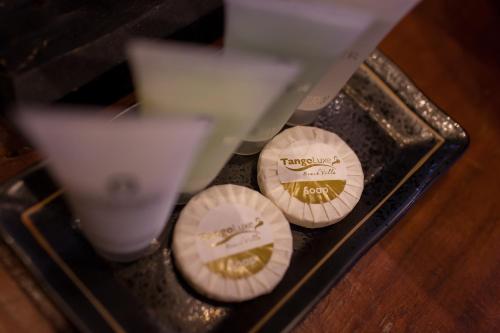 two cups sitting on top of a table at Tango Luxe Beach Villa, Koh Samui in Choeng Mon Beach