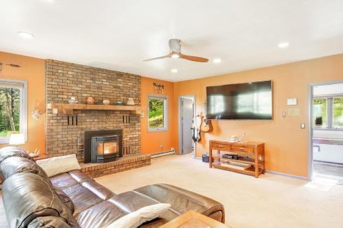 a living room with a couch and a fireplace at The Four Pines Near to Red Rocks And Morrison in Morrison