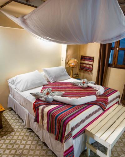 a bedroom with a bed with towels on it at Casa Marimba in La Laguna