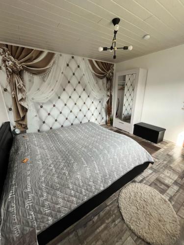 a bedroom with a large bed with a wall at Ferienwohnung Santino in Goslar